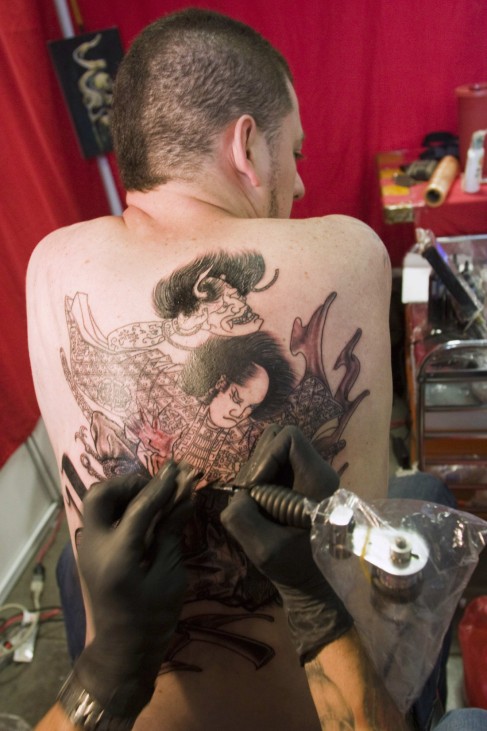 A man gets a tattoo during the 2nd Annual Tattoo Expo in Medellin