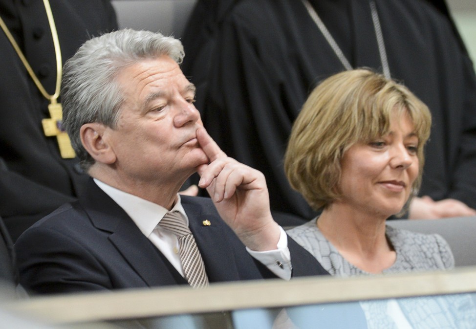 German presidential candidate Gauck and his partner Schadt listen during Germany's Federal Assembly in Berlin