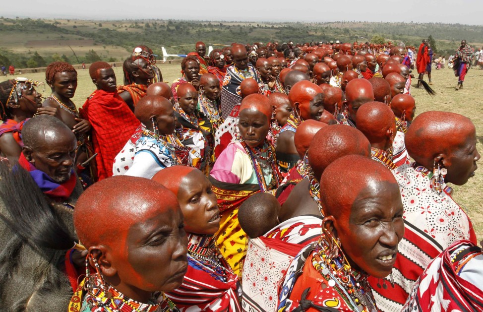 Maasai women, with their heads decorated with red ochre, attend the preparation of 'Entoto', a traditional coming-of-age ceremony in Olkerin Manyatta