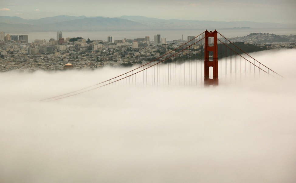 The skyline of San Francisco and the south tower of the Golden Gate Bridge are seen from the Marin Headlands as they rise above the fog in Sausalito
