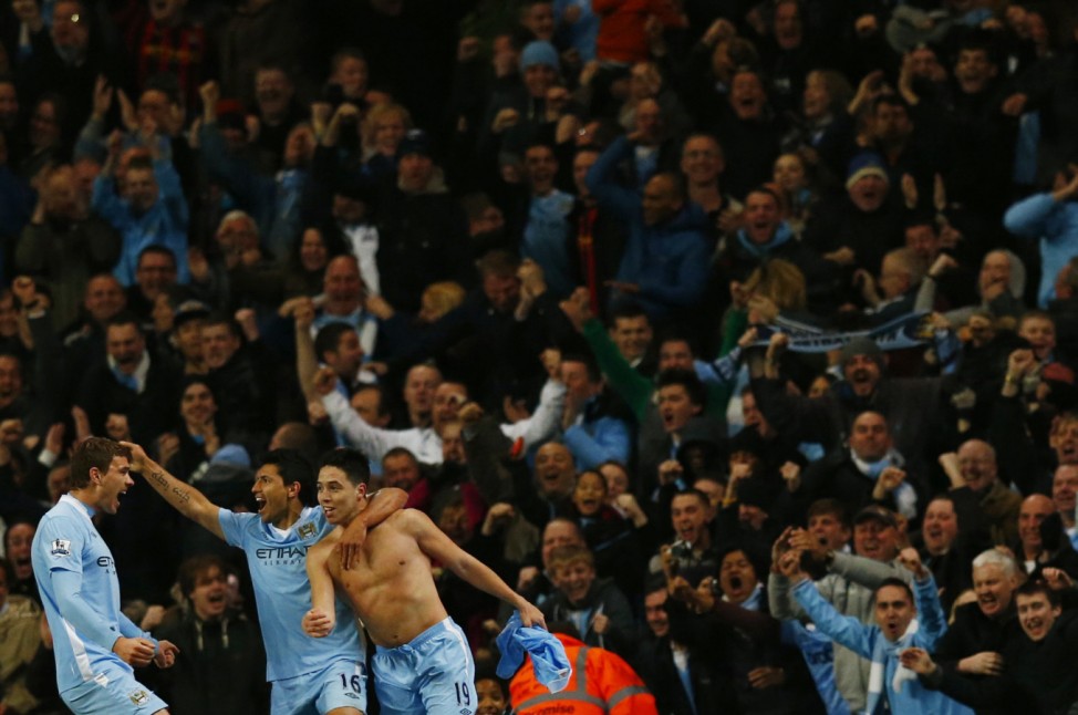 Manchester City's Nasri celebrates with teammates Aguero and Dzeko after scoring against Chelsea during their English Premier League soccer match in Manchester