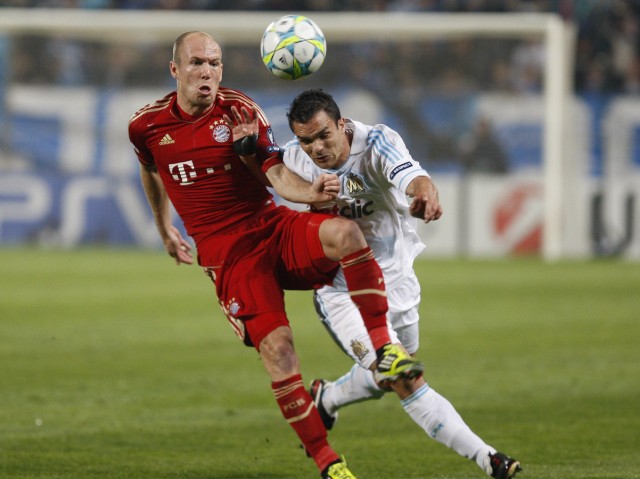 Olympique Marseille's Morel challenges Bayern Munich's Robben during their quarter-final first leg Champions League soccer match at the Velodrome Stadium in Marseille