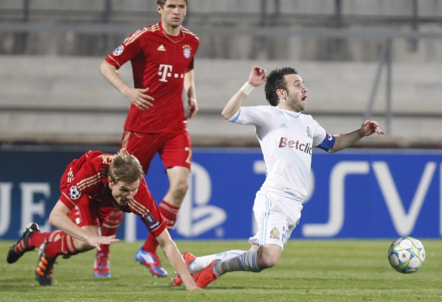 Olympique Marseille's Valbuena challenges Bayern Munich's Badstuber during their quarter-final first leg Champions League soccer match at the Velodrome Stadium in Marseille