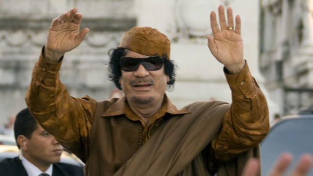 Libya's leader Gaddafi greets Romans from the sunroof of his limousine while forming an impromptu parade in Piazza Venezia in Rome