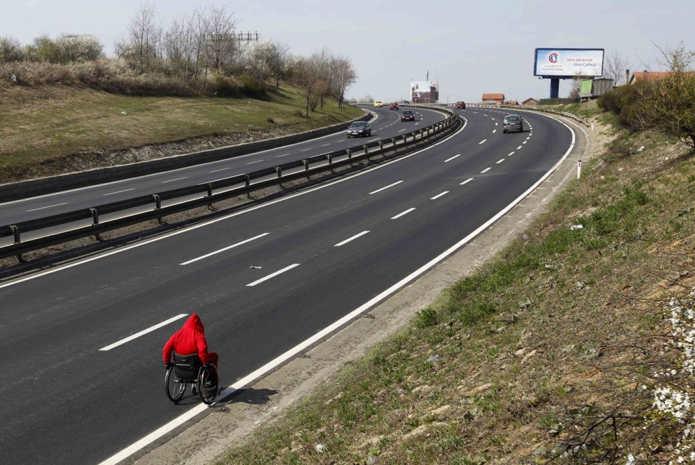 Macedonian paraplegic athlete Stojkoski pushes himself on a highway during a marathon from his native town of Krusevo to the London Olympics, in Belgrade