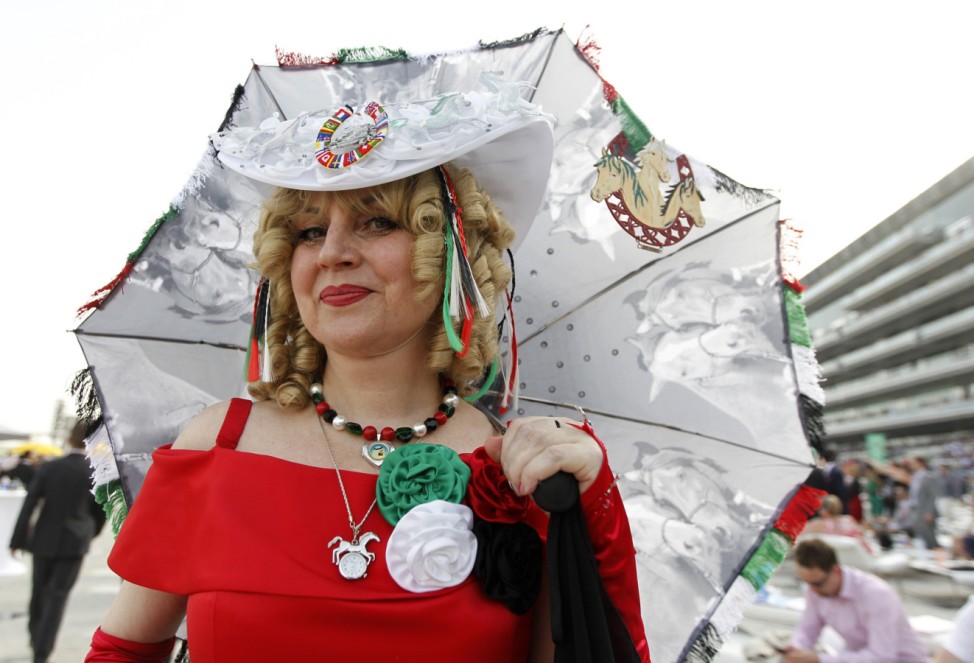 Dietrich of Germany poses with her umbrella ahead of 17th Dubai World Cup at the Meydan racecourse in Dubai