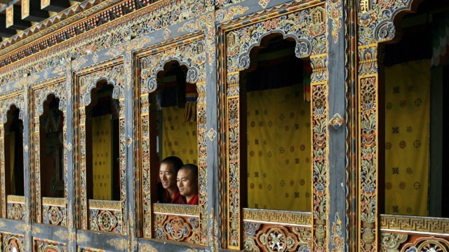 Monks look out of a temple in Tango monastery on the outskirts of Thimphu