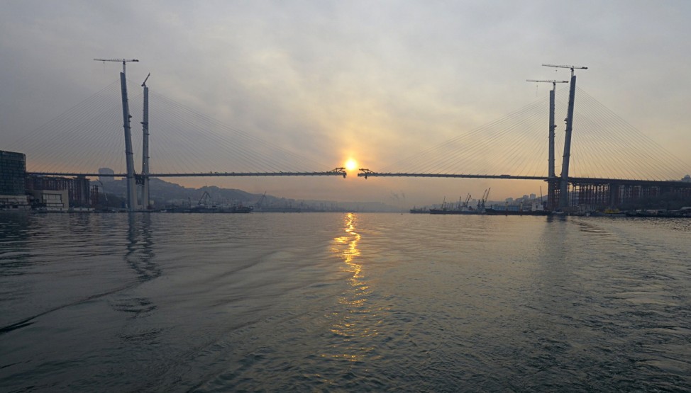 A bridge over the Golden Horn Bay is seen under construction during sunrise in the far eastern port of Vladivostok