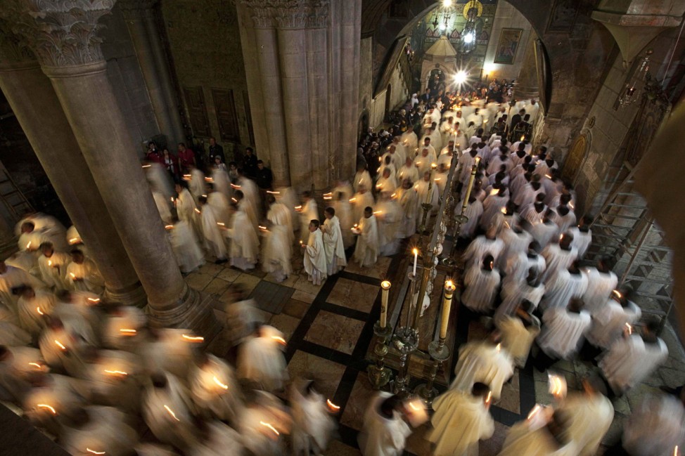 Members of the Catholic clergy hold candles during Washing of the Feet ceremony ahead of Easter in Jerusalem