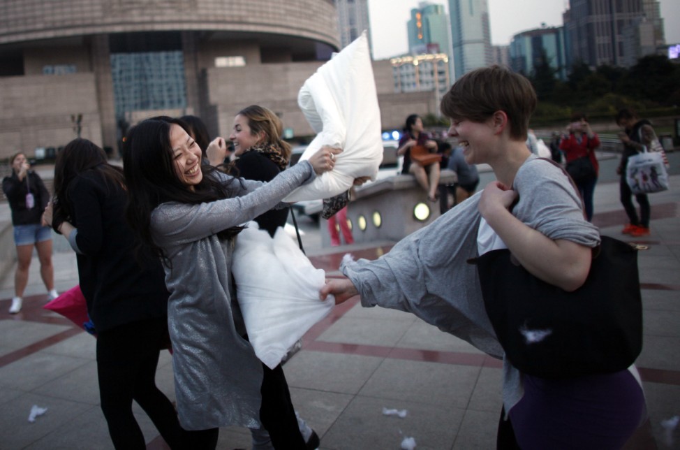 People take part in a pillow fight event on international Pillow Fight Day at People Square in Shanghai