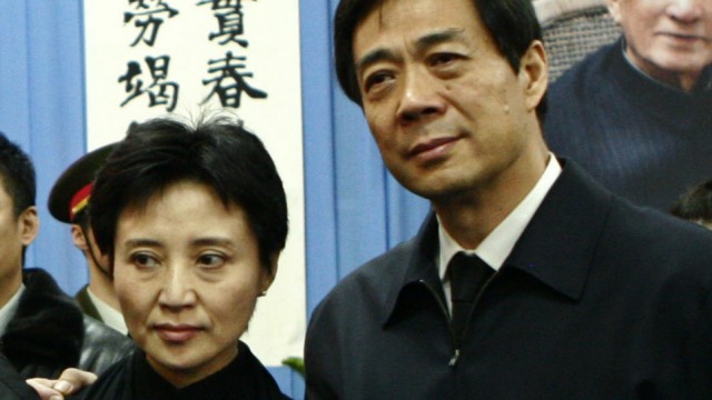 China's former Chongqing Municipality Communist Party Secretary Bo and his wife pose for group photos at a mourning in Beijing