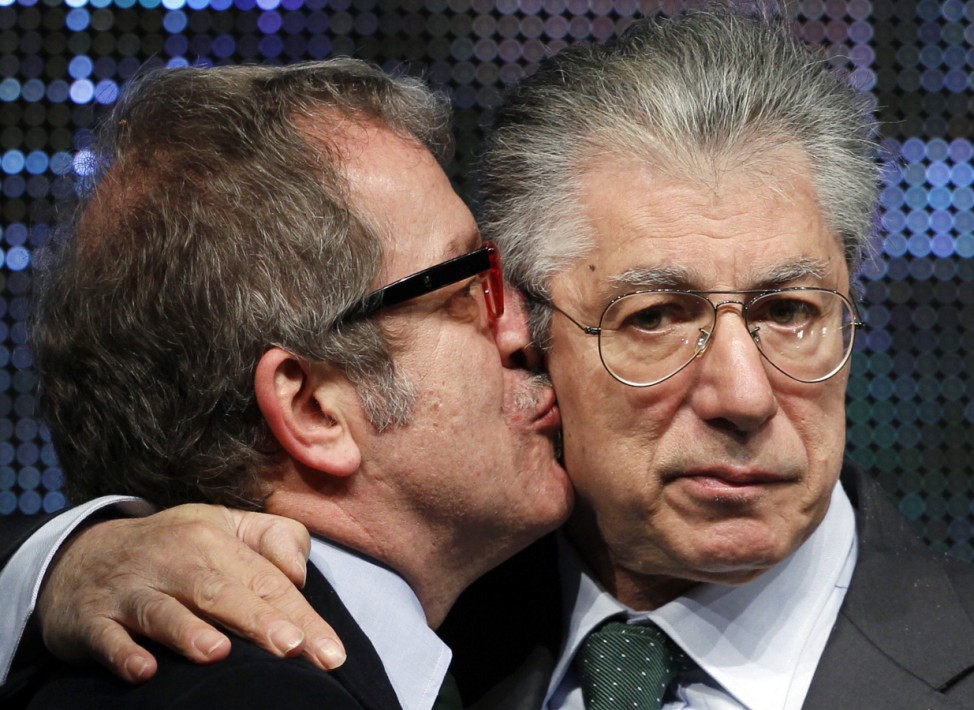 Italy's Northern League member Maroni kisses former leader Bossi during the Northern League party rally in Bergamo
