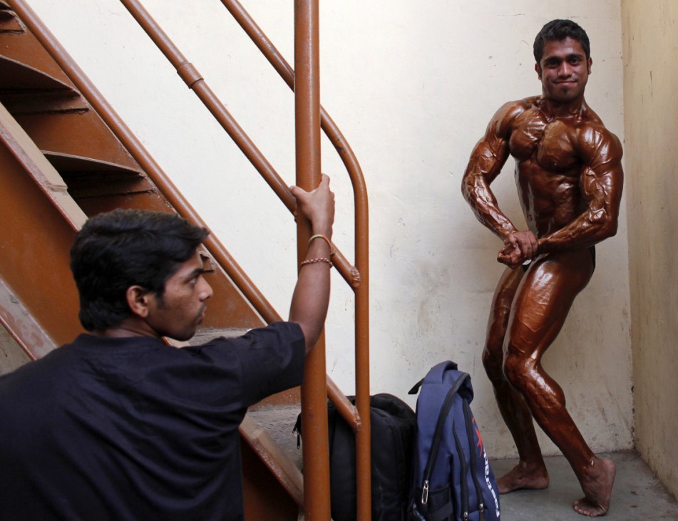A competitor poses backstage during the screening session for Mr. Mumbai body building competition in Mumbai