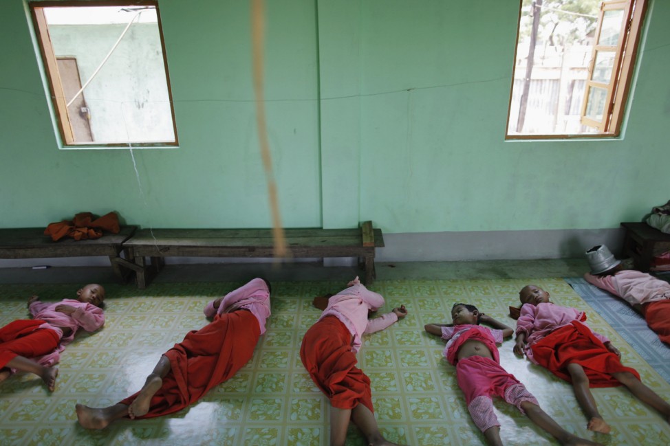 Girls sleep on the floor of a nunnery, where orphans become Buddhist novice nuns, in the suburbs of Yangon