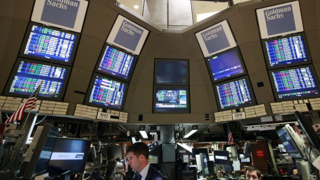 Traders work at the Goldman Sachs kiosk on the floor of the New York Stock Exchange