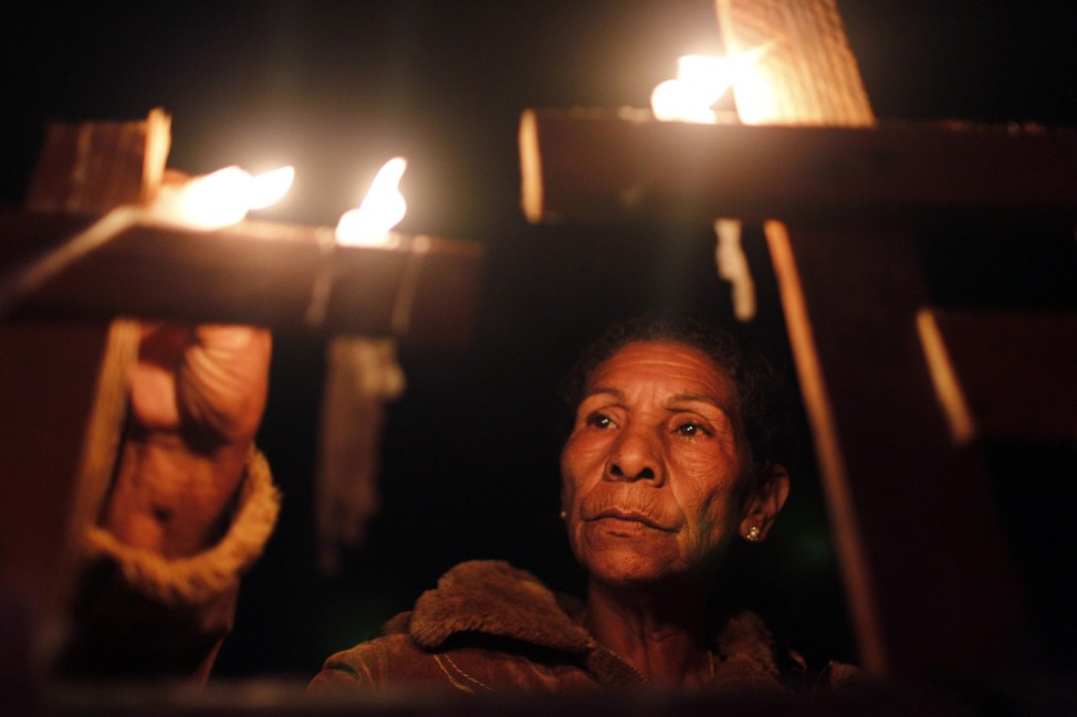 Members of the Landless Movement (MST) light candles during a protest in Brasilia