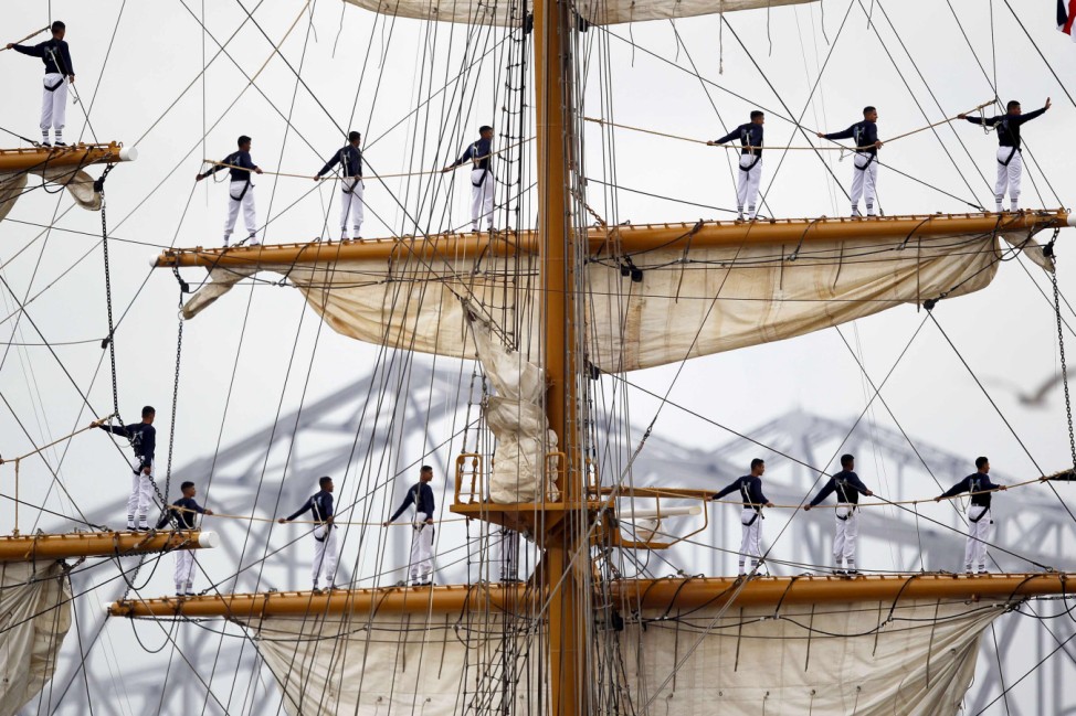 Crew members of the Guayas-Ecuadorian Tall Ship stand atop the ship mast as they make their way up the Mississippi River into the Port of New Orleans during NOLA Navy Week and Commemoration of the Bicentennial of the War of 1812 in New Orleans, Louisiana