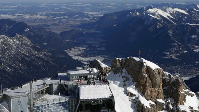 The summit cross on Germany's highest mountain Zugspitze is pictured in front of the panorama of the Austrian Alps near Garmisch-Partenkirchen