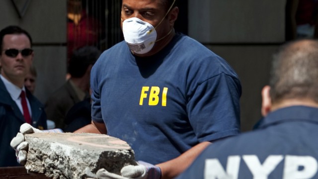 FBI agents and New York City police officers remove concrete from a New York City apartment building where they were searching a basement for clues in the 1979 disappearance of Etan Patz