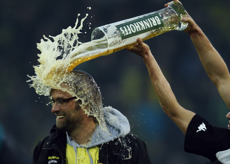 Borussia Dortmund's Piszczek pours beer over coach Klopp after winning German Championship following German first division Bundesliga soccer match against Borussia Moenchengladbach in Dortmund