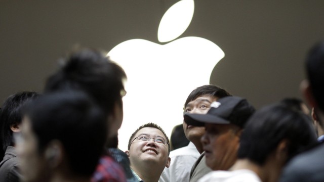 File photo of people attending the inauguration of the new Apple store in Nanjing Road, downtown Shanghai