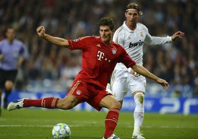 Bayern Munich's Gomez challenges Real Madrid's Ramos during their Champions League semi-final second leg soccer match at Santiago Bernabeu stadium in Madrid