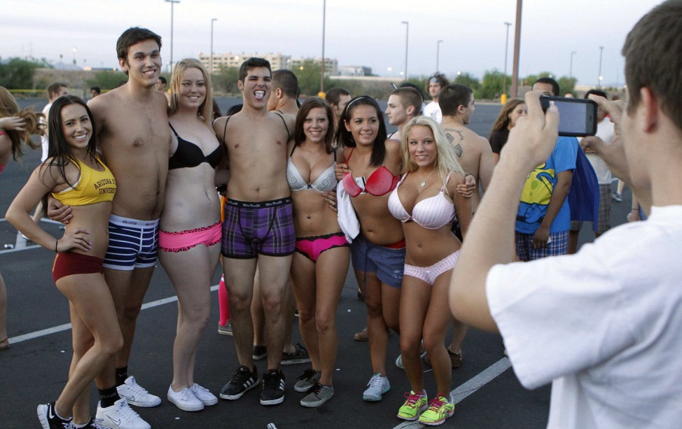 Arizona State University students pose for photo as they celebrate last day of classes by taking off their clothes and donating them to charity during ASU Undie Run 2012 in Tempe