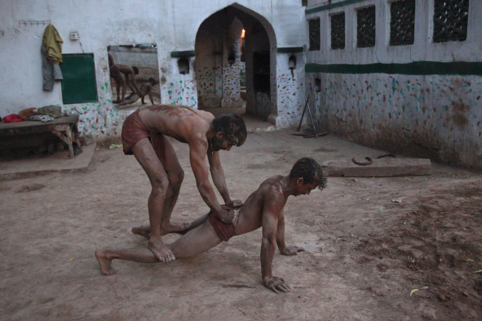 Wrestlers exercise in mud at a traditional Pakistani wrestling training centre called 'Akhaara' in the old city of Lahore