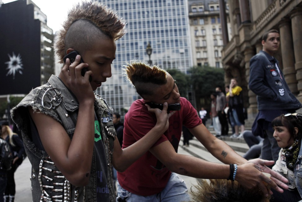 Brazilian punks use their mobile phones during a May Day demonstration on Labour Day in downtown Sao Paulo