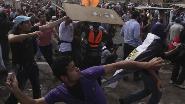 Protesters throw stones at army soldiers during clashes at Abbasiya square near Egypt's Defence Ministry in Cairo