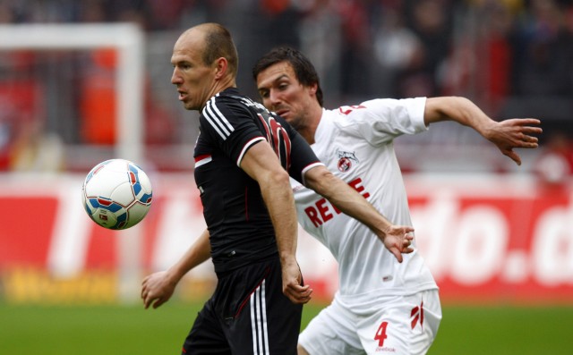 Cologne's Eichner challenges Munich's Robben during their German Bundesliga soccer match in Cologne