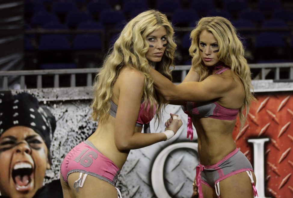 Lingerie Football League's Liz Gorman of the Eastern Conference poses with Natalie Jahnke of the Western Conference before a pratice session in Mexico City