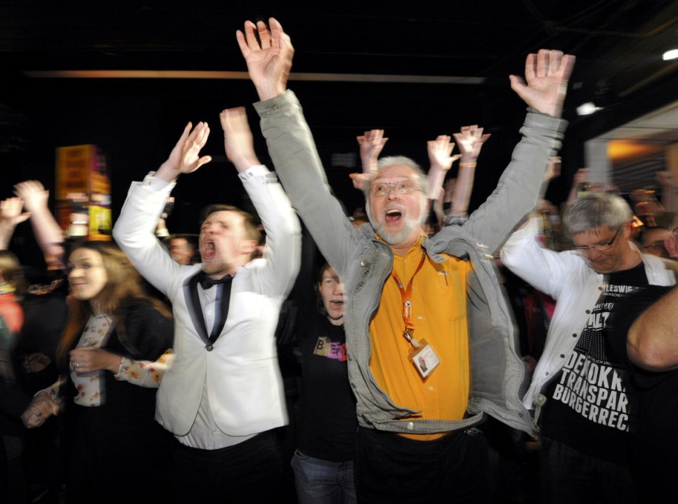 Supporters of Die Piraten (The Pirates) party react after first exit polls for the federal state elections of Germany's northern state of Schleswig-Holstein in Kiel