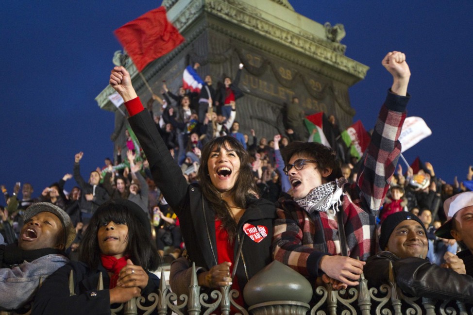 Supporters of Francois Hollande, Socialist Party candidate for the 2012 French presidential election, celebrate at a rally at Place de la Bastille in Paris