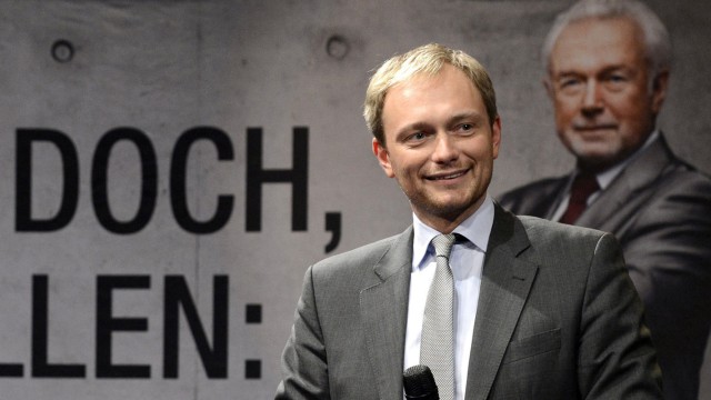 Christian Lindner is pictured in front of an election poster showing Wolfgang Kubicki during an election rally in Kiel