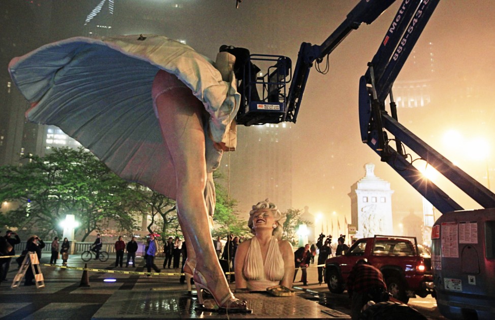 A worker looks inside a disassembled 26-foot tall statue of Marilyn Monroe in Chicago