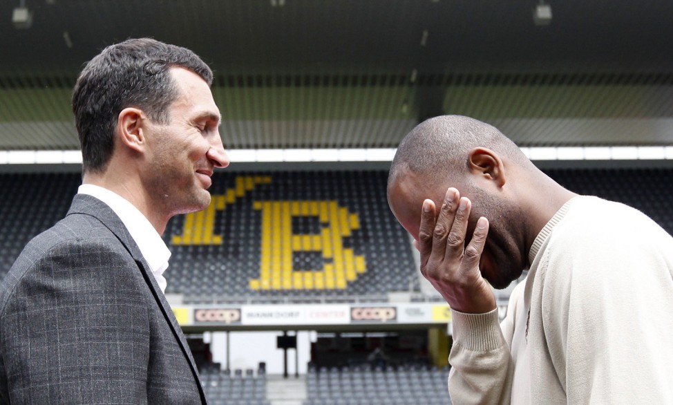 Heavyweight boxing title holder Klitschko of Ukraine and US boxing contender Thompson try to keep straight faces as pose after news conference at the Stade de Suisse in Bern