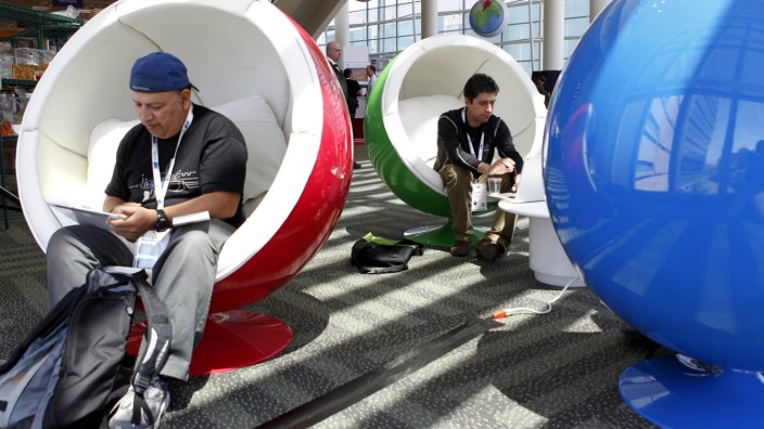 Attendees use their machines as they take a break at the Google I/O Developers Conference in the Moscone Center in San Francisco