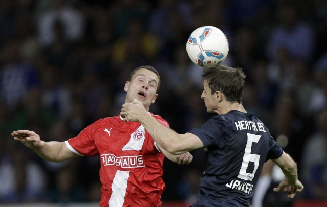 Hertha Berlin's Jancker and Fortuna Duesseldorf's Broeker head for ball during the German Bundesliga first division relegation soccer match in Berlin