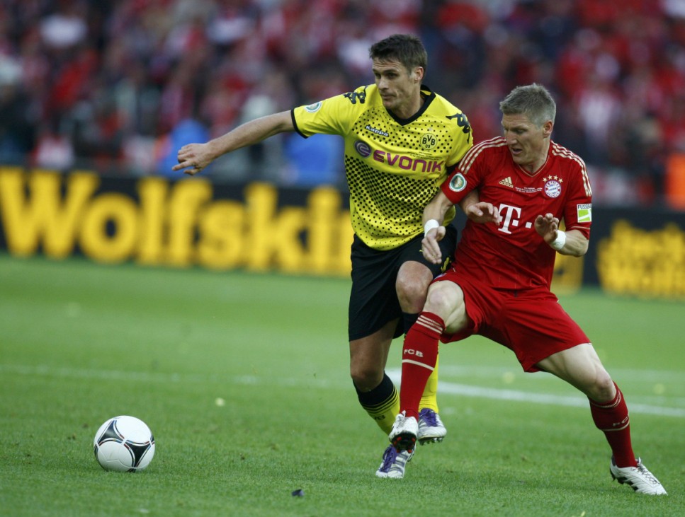 Bayern Munich's Schweinsteiger challenges Borussia Dortmund's Kehl during the German DFB Cup final soccer match in Berlin
