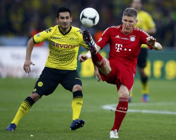 Borussia Dortmund's Guendogan battles for the ball with Bayern Munich's Schweinsteiger during their German DFB Cup (DFB Pokal) final soccer match at the Olympic stadium in Berlin