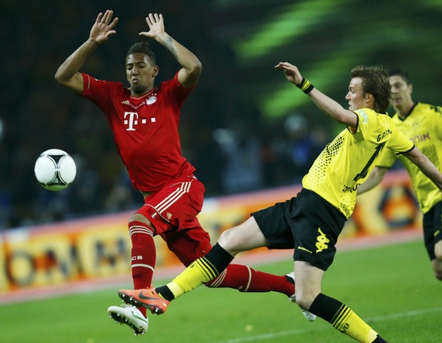 Bayern Munich's Boateng challenges Borussia Dortmund's Groskreutz during the German DFB Cup final soccer match in Berlin