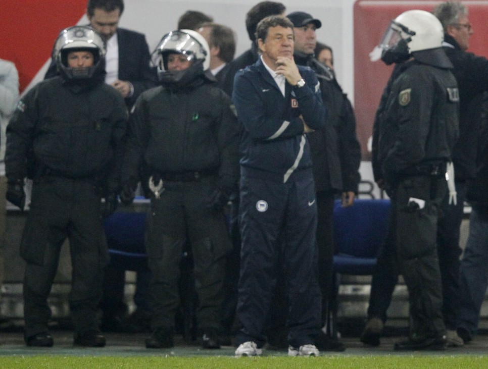 Hertha Berlin coach Rehhagel is surrounded by German riot police during German Bundesliga soccer division relegation match against Fortuna Duesseldorf in Duesseldorf