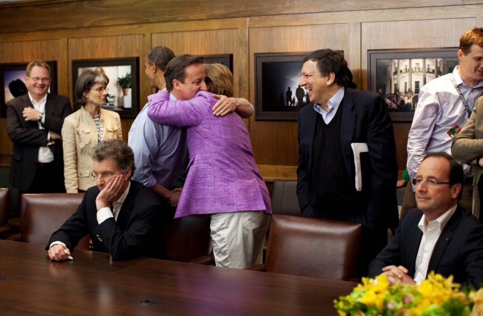 Barroso, watches as Cameron hugs Merkel following the overtime shootout of the Chelsea vs. Bayern Munich Champions League final in the Laurel Cabin conference room during the G8 Summit at Camp David