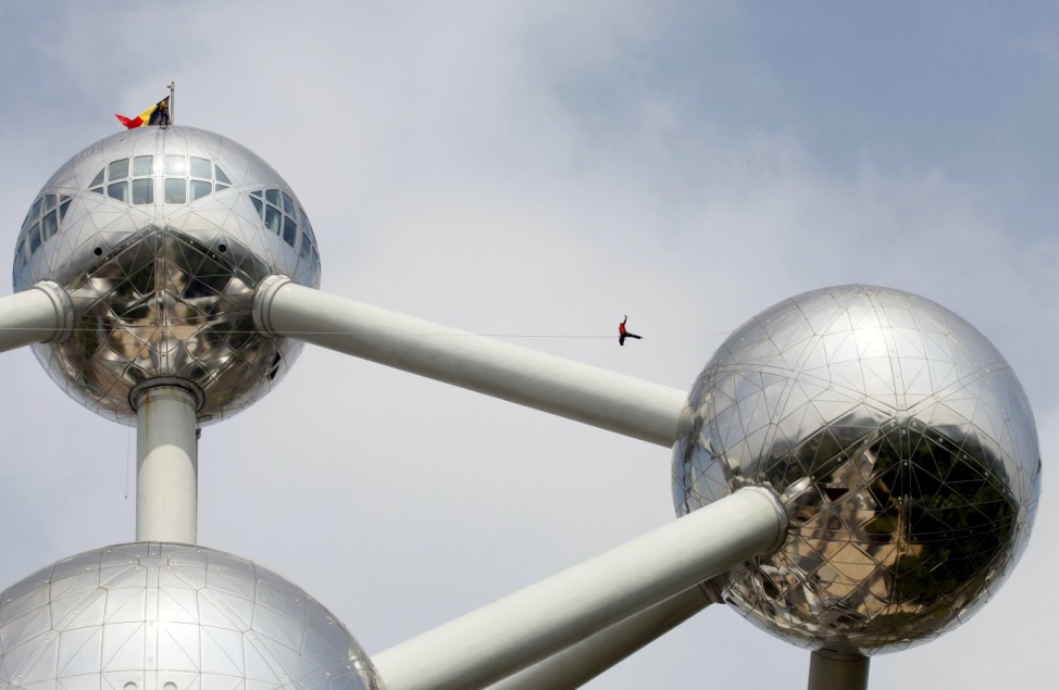 A tightrope walker practises between two spheres of the Atomium monument in Brussels