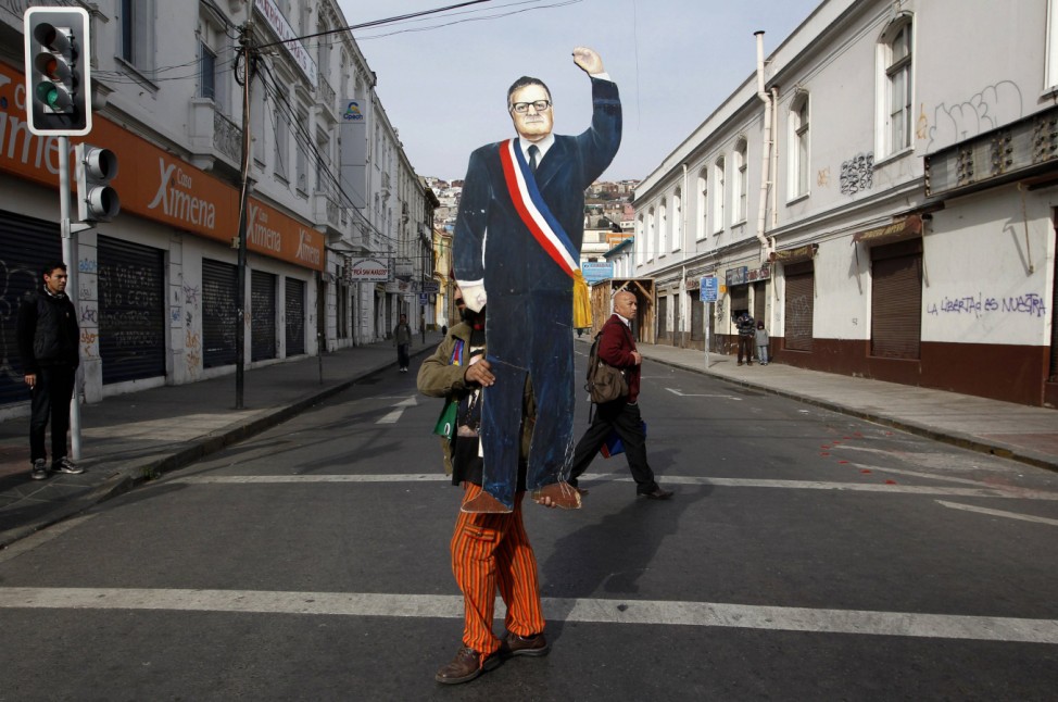 A man carries a cut-out of former president Allende  in Valparaiso city