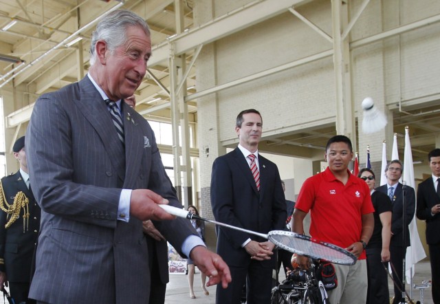 Britain's Prince Charles plays badminton as Ontario Premier Dalton McGuinty and Olympic archer Crispin Duenas look on in Toronto