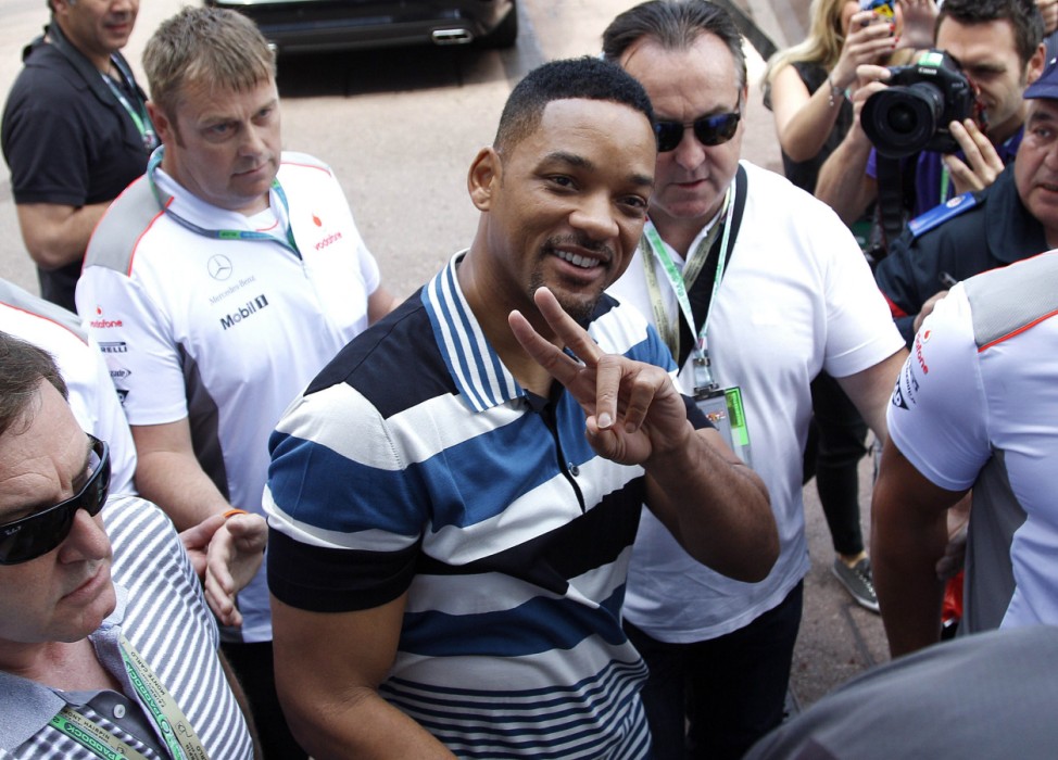U.S. actor Smith flashes the victory sign as he arrives in the paddocks during the Monaco F1 Grand Prix