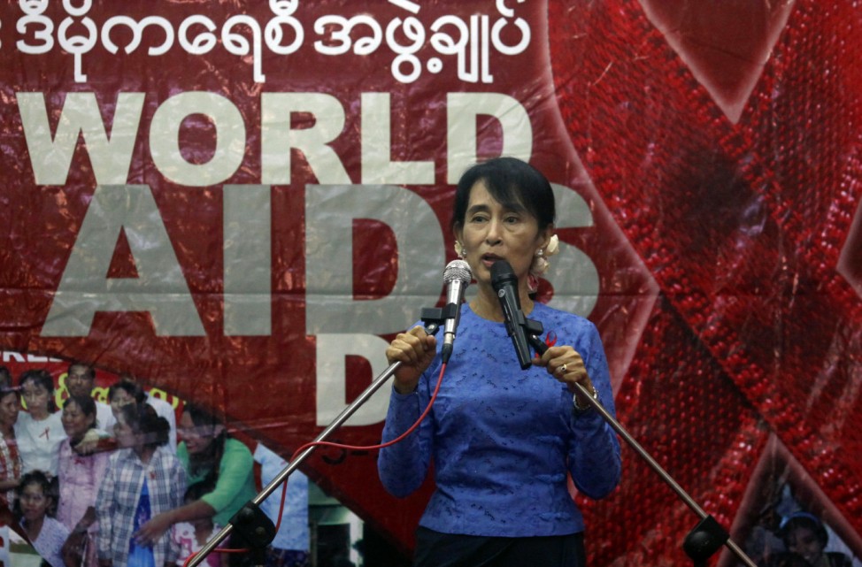Myanmar's pro-democracy leader Aung San Suu Kyi talks to HIV/AIDS patients during a ceremony to mark World AIDS Day in Yangon
