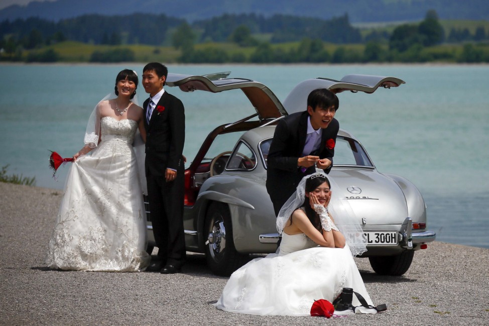 Chinese bridal couples pose after their symbolic wedding in Fuessen